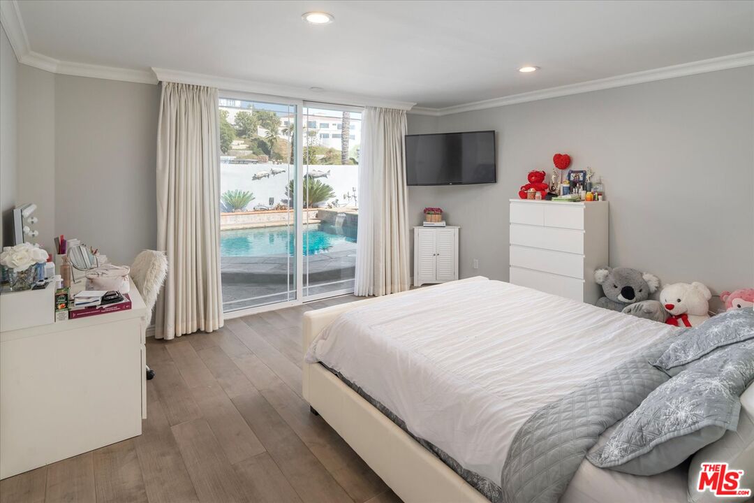 1975 Deermont Road Glendale, CA 91207 - Photo 26 of 42 a bedroom with a bed and a large window