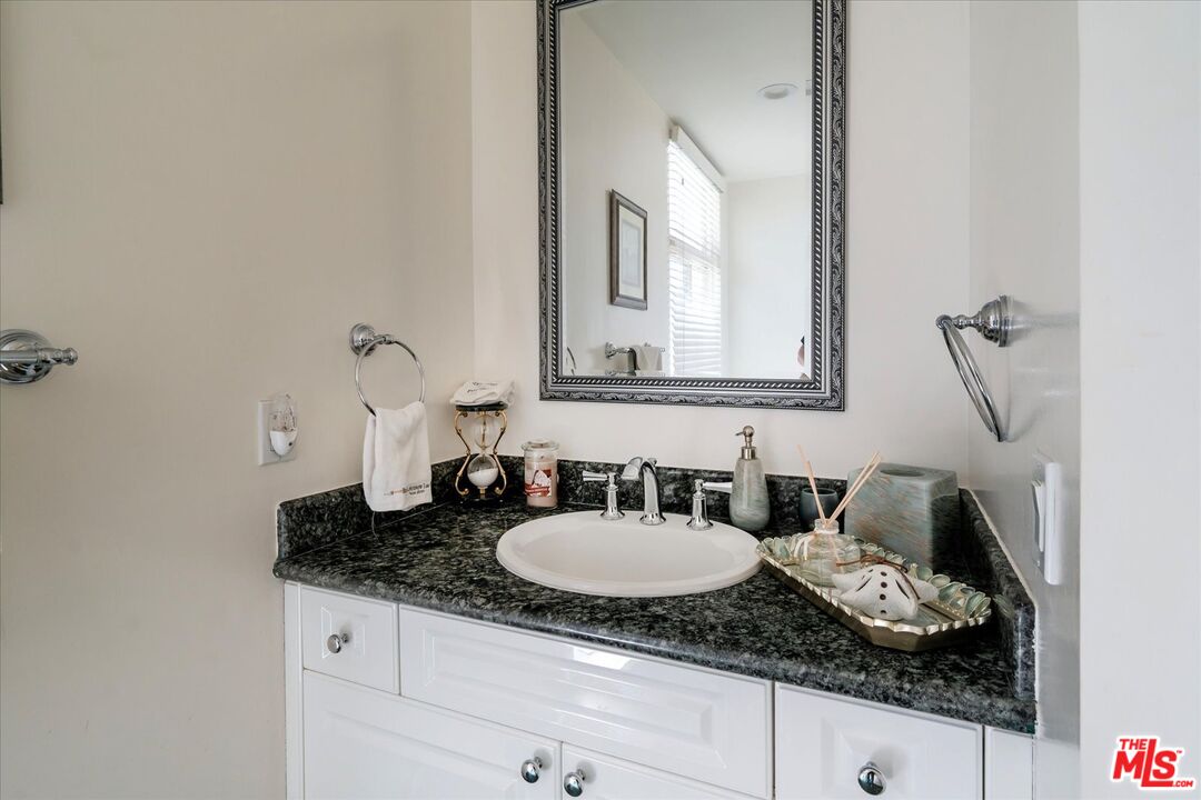 1975 Deermont Road Glendale, CA 91207 - Photo 30 of 42 a bathroom with a granite countertop sink and a mirror