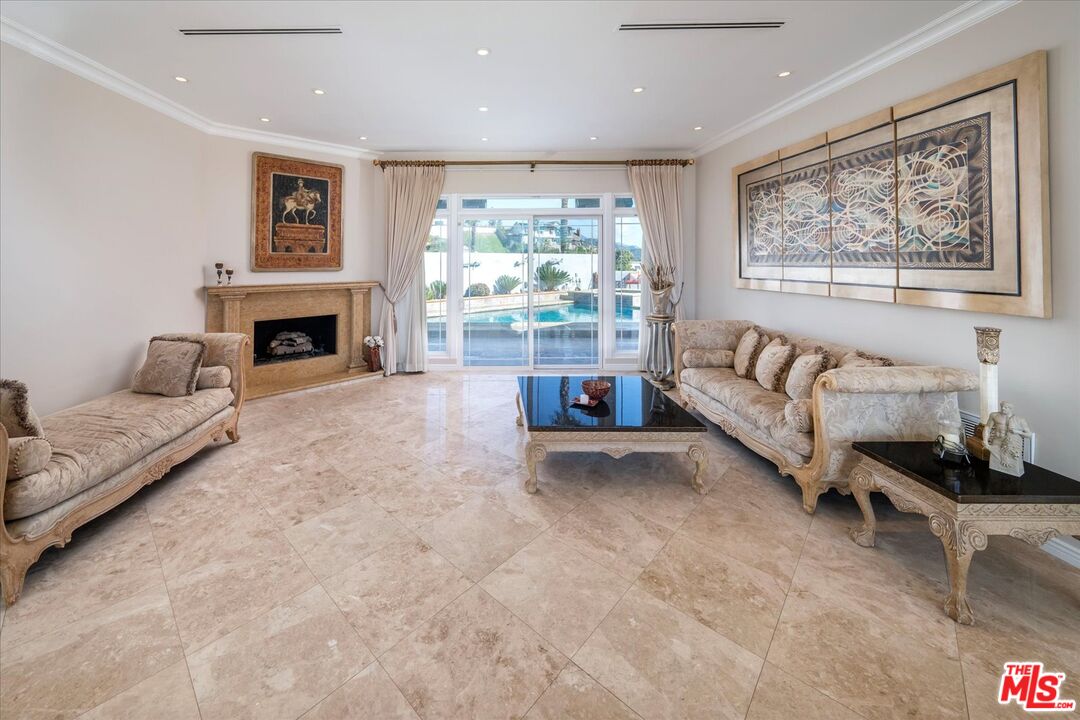 1975 Deermont Road Glendale, CA 91207 - Photo 5 of 42 a living room with furniture large window and a fireplace