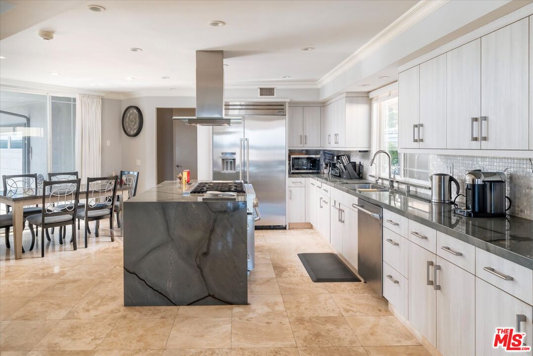 1975 Deermont Road Glendale, CA 91207 - Photo 10 of 42 a kitchen with stainless steel appliances granite countertop a refrigerator a sink a stove and white cabinets