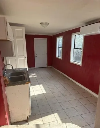 a view of a livingroom with an empty space and a window