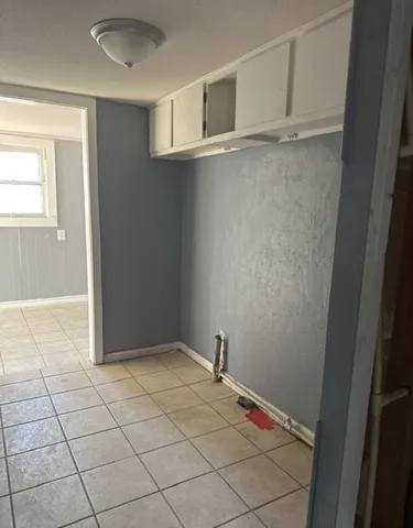 a view of a room with an empty space and a window