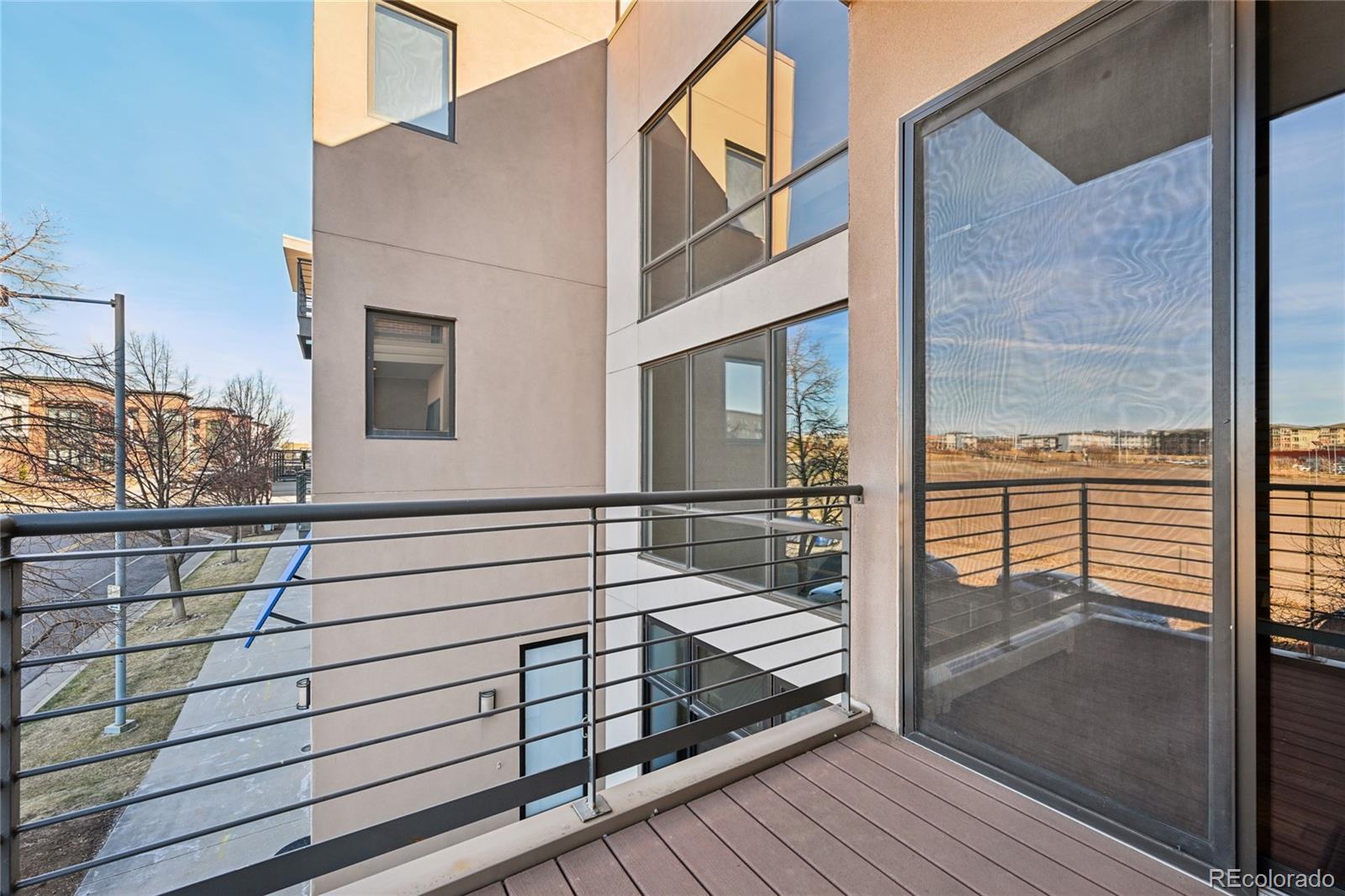 11562 Colony Row Broomfield, CO 80021 - Photo 21 of 48 a view of a balcony with wooden floor and iron stairs