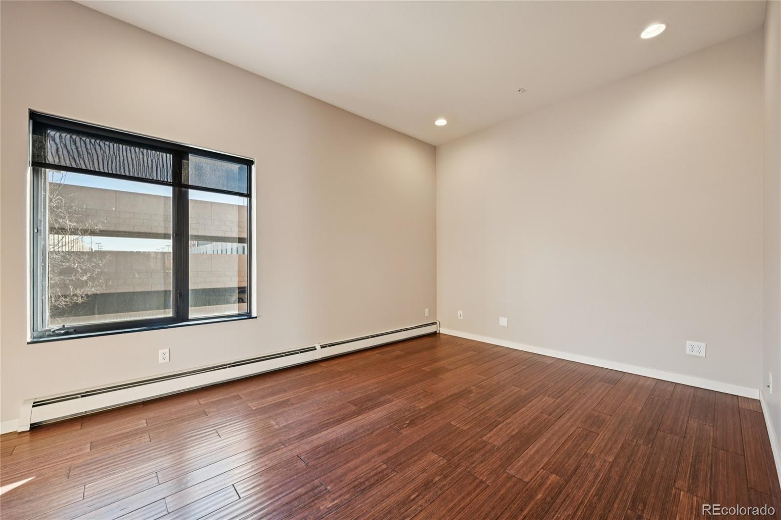 11562 Colony Row Broomfield, CO 80021 - Photo 24 of 48 an empty room with wooden floor and windows