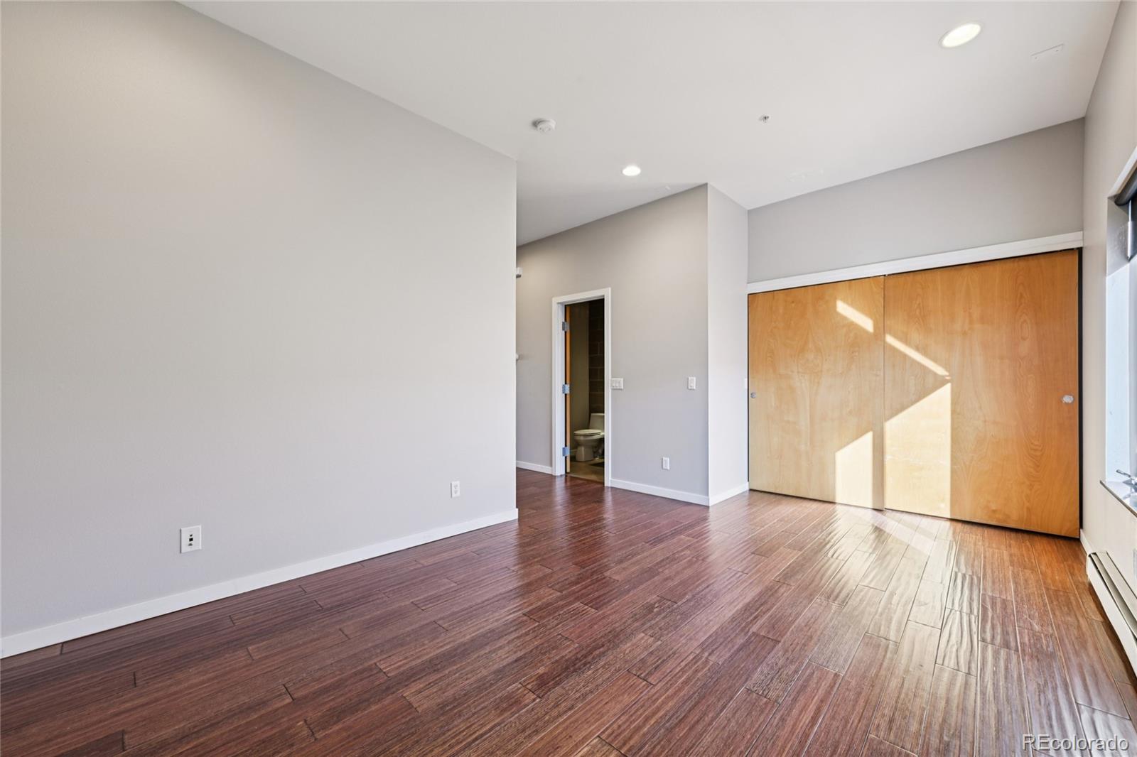 11562 Colony Row Broomfield, CO 80021 - Photo 25 of 48 a view of an empty room with wooden floor and a window