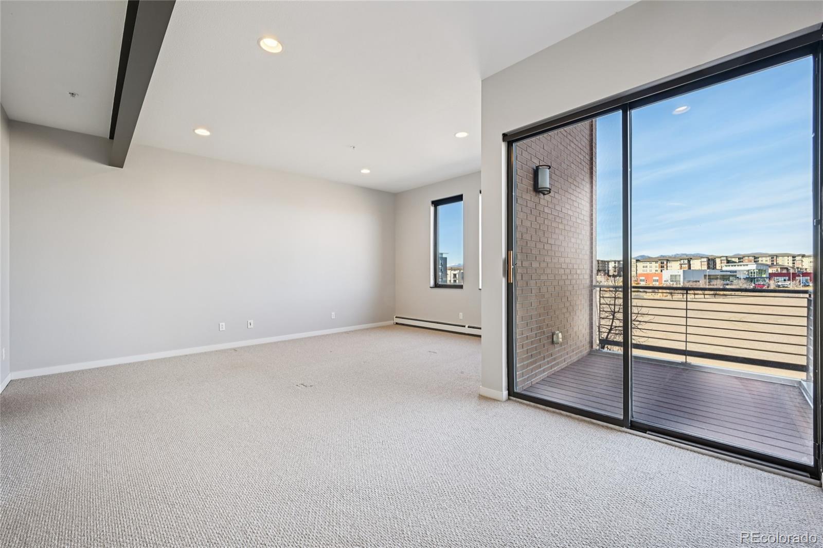 11562 Colony Row Broomfield, CO 80021 - Photo 31 of 48 an empty room with large windows