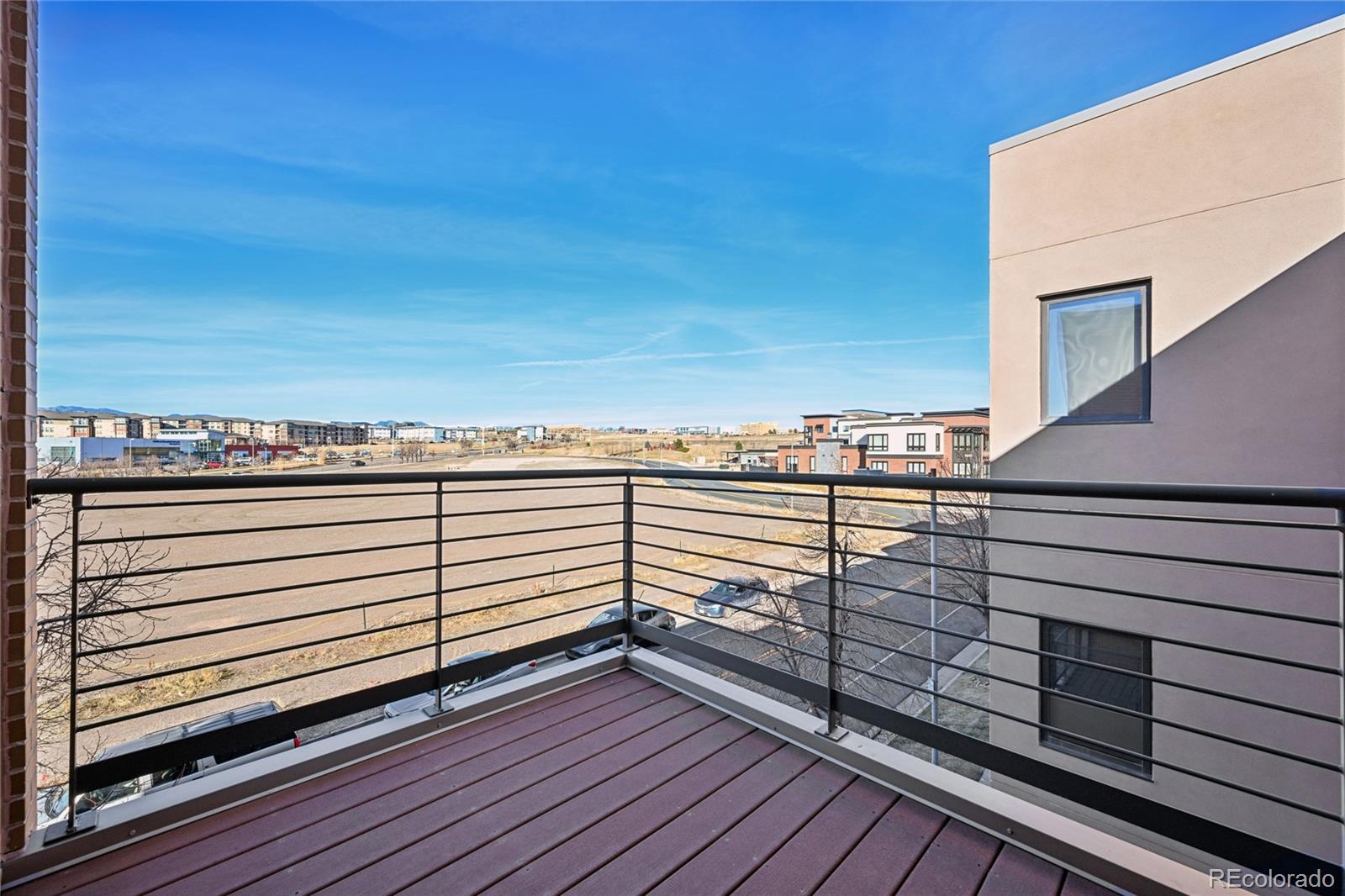 11562 Colony Row Broomfield, CO 80021 - Photo 32 of 48 a view of a balcony with wooden floor and city view