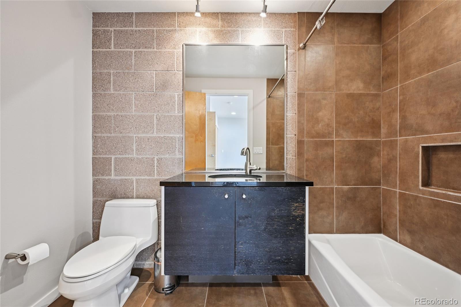 11562 Colony Row Broomfield, CO 80021 - Photo 41 of 48 a bathroom with a granite countertop bathtub sink vanity mirror and toilet