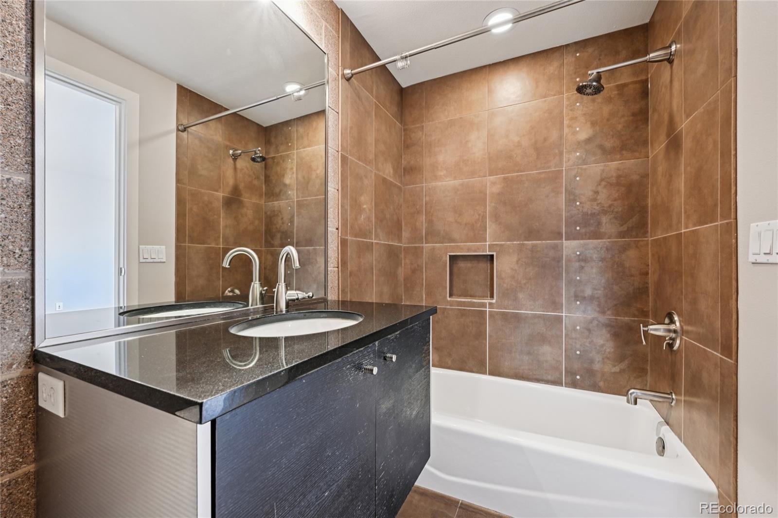 11562 Colony Row Broomfield, CO 80021 - Photo 42 of 48 a bath tub sitting next to a bathroom sink