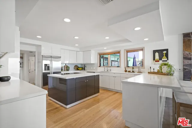 a living room with furniture and a painting on the wall