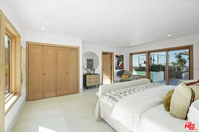 a spacious bedroom with a large bed and a window