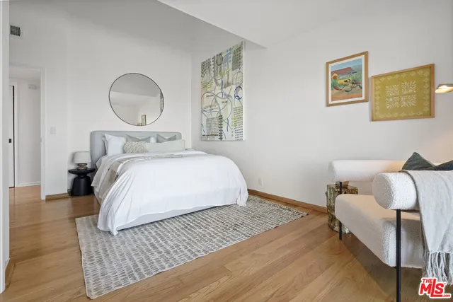 a bedroom with a bed and a dresser