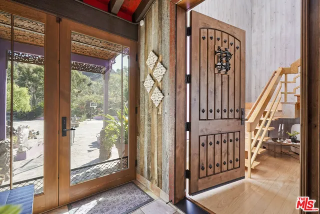 a view of a terrace with furniture and city view