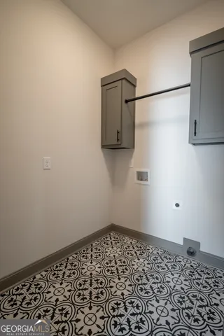 a white bath tub sitting in a bathroom next to a window