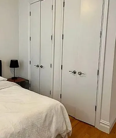 a bedroom with a bed and a table