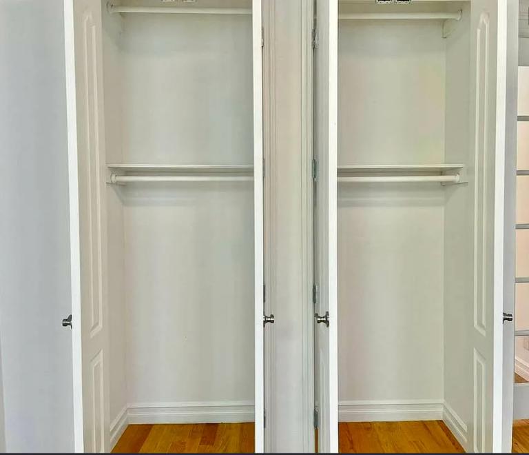 886 10th Avenue, Unit 5B Manhattan, NY 10019 - Photo 4 of 6 a bathroom with a glass shower door