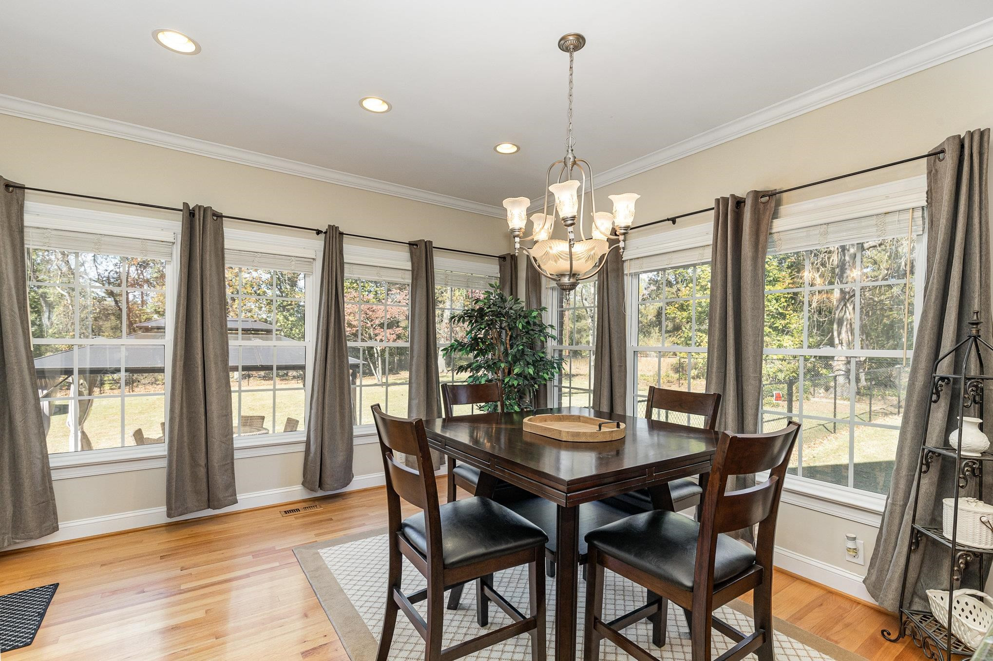 4046 Fairground Road Dunn, NC 28334 - Photo 11 of 50 a view of a dining room with furniture large windows and wooden floor
