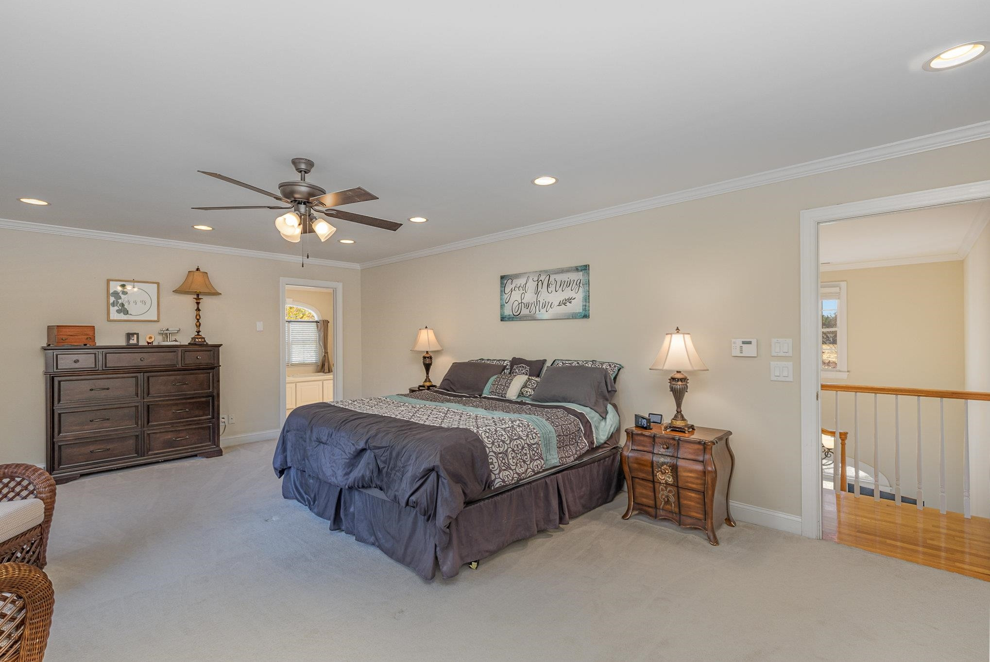 4046 Fairground Road Dunn, NC 28334 - Photo 23 of 50 a spacious bedroom with a bed and a chandelier