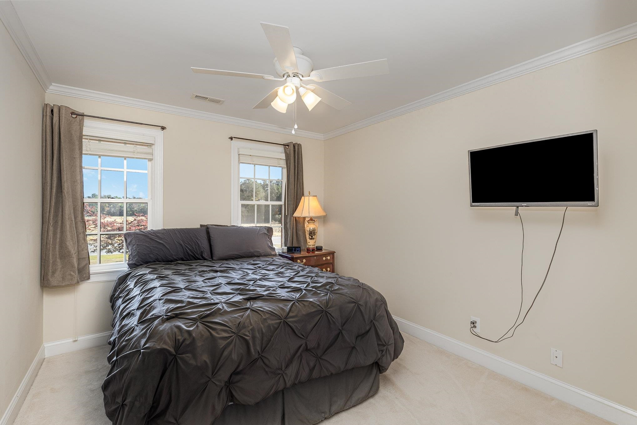 4046 Fairground Road Dunn, NC 28334 - Photo 32 of 50 a bedroom with a bed and a flat screen tv