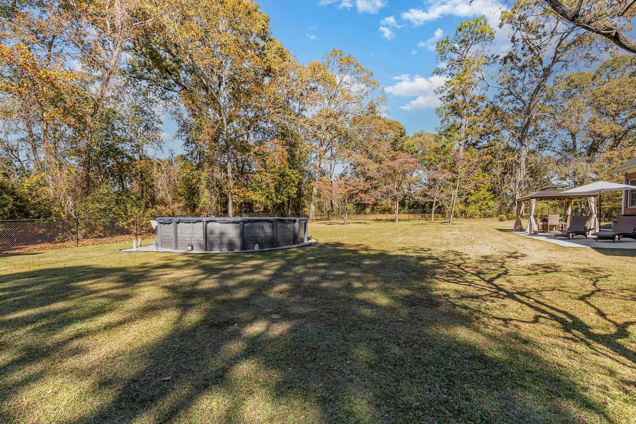 4046 Fairground Road Dunn, NC 28334 - Photo 43 of 50 a view of yard with swimming pool and trees
