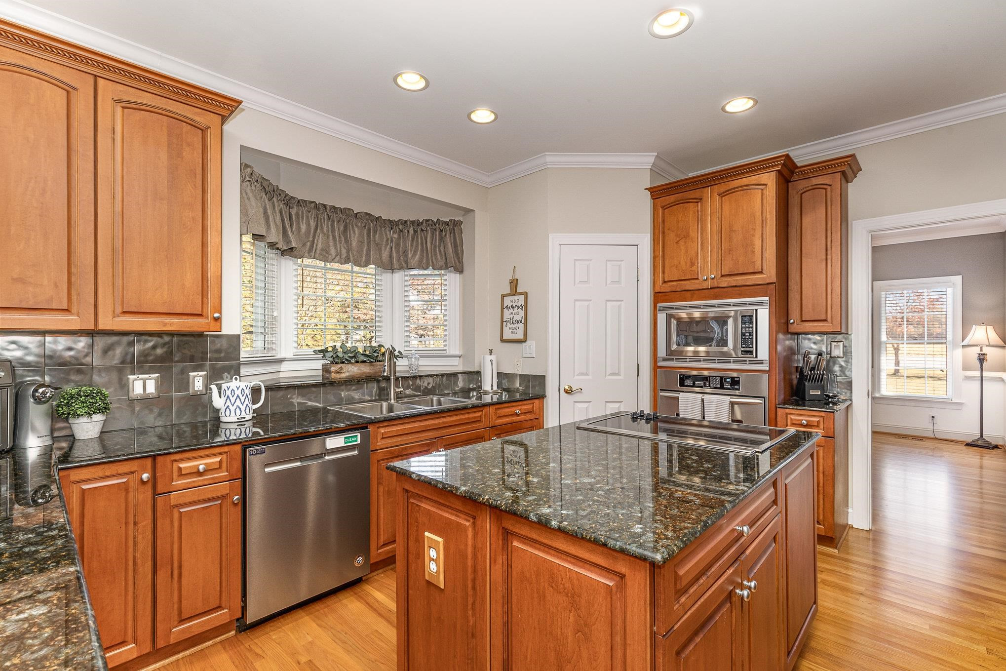 4046 Fairground Road Dunn, NC 28334 - Photo 9 of 50 a kitchen with stainless steel appliances granite countertop a sink stove and cabinets