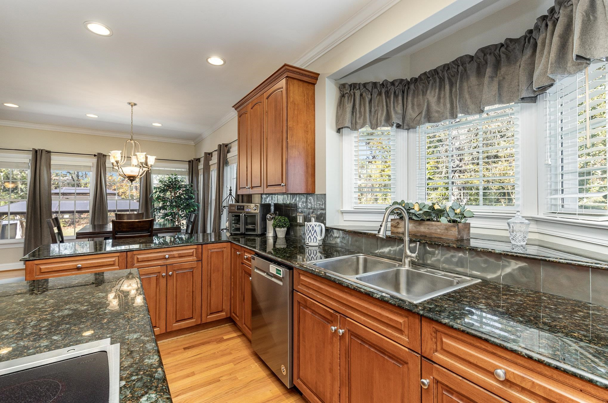 4046 Fairground Road Dunn, NC 28334 - Photo 10 of 50 a kitchen with stainless steel appliances granite countertop sink stove and cabinets