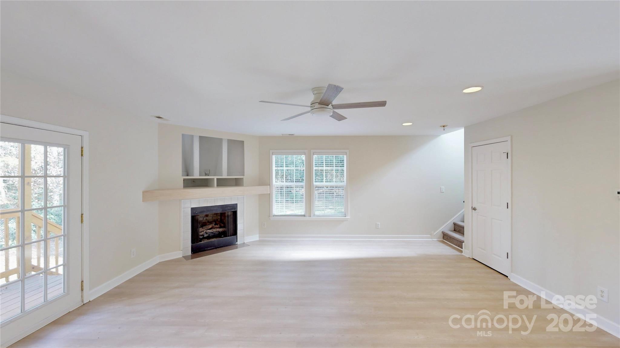 2844 Goneaway Road Charlotte, NC 28210 - Photo 12 of 41 a view of an empty room with a fireplace and a window