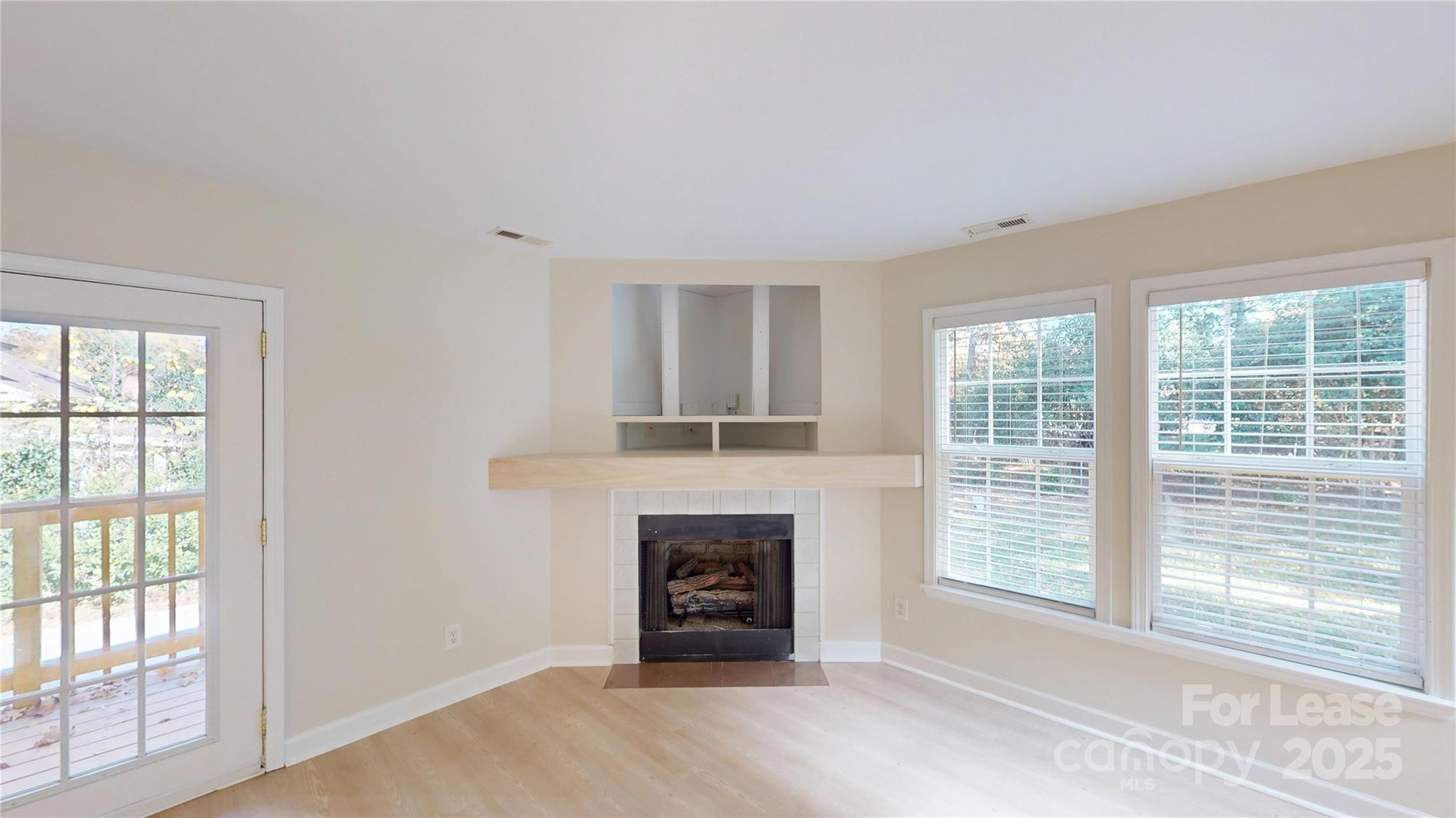 2844 Goneaway Road Charlotte, NC 28210 - Photo 13 of 41 a view of an empty room with a window and fireplace