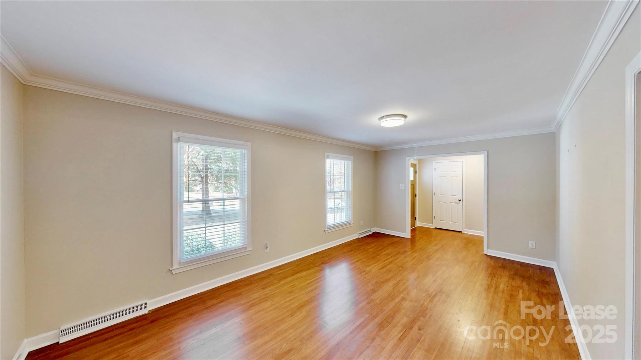 2844 Goneaway Road Charlotte, NC 28210 - Photo 23 of 41 a view of an empty room with wooden floor and a window