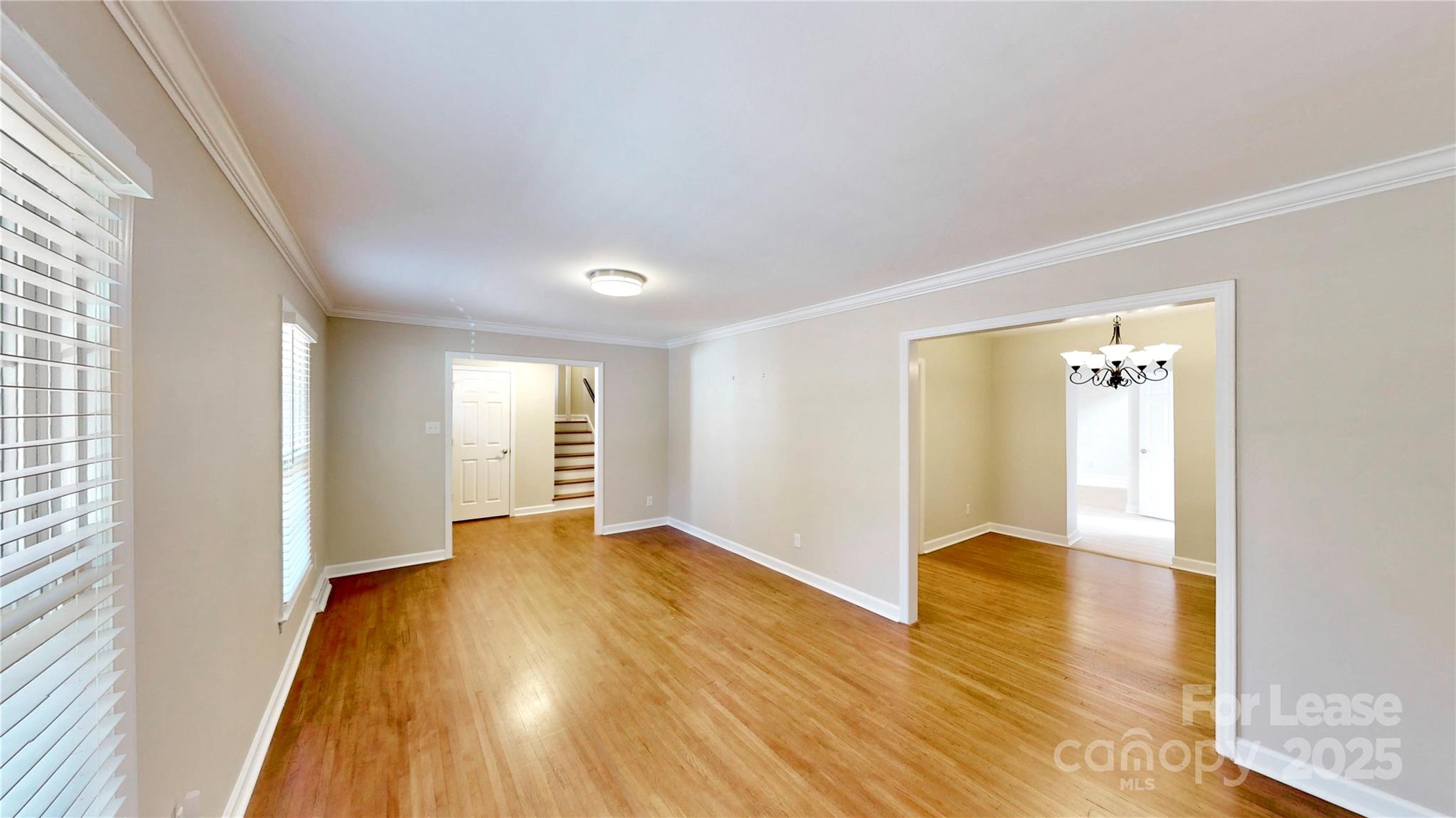 2844 Goneaway Road Charlotte, NC 28210 - Photo 24 of 41 a view of an empty room with wooden floor and a window