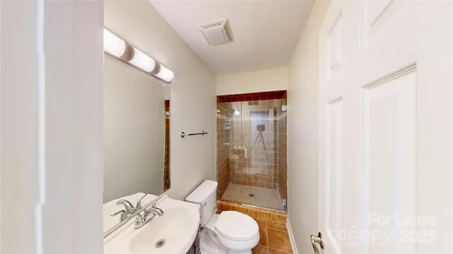 a bathroom with a toilet a sink and shower