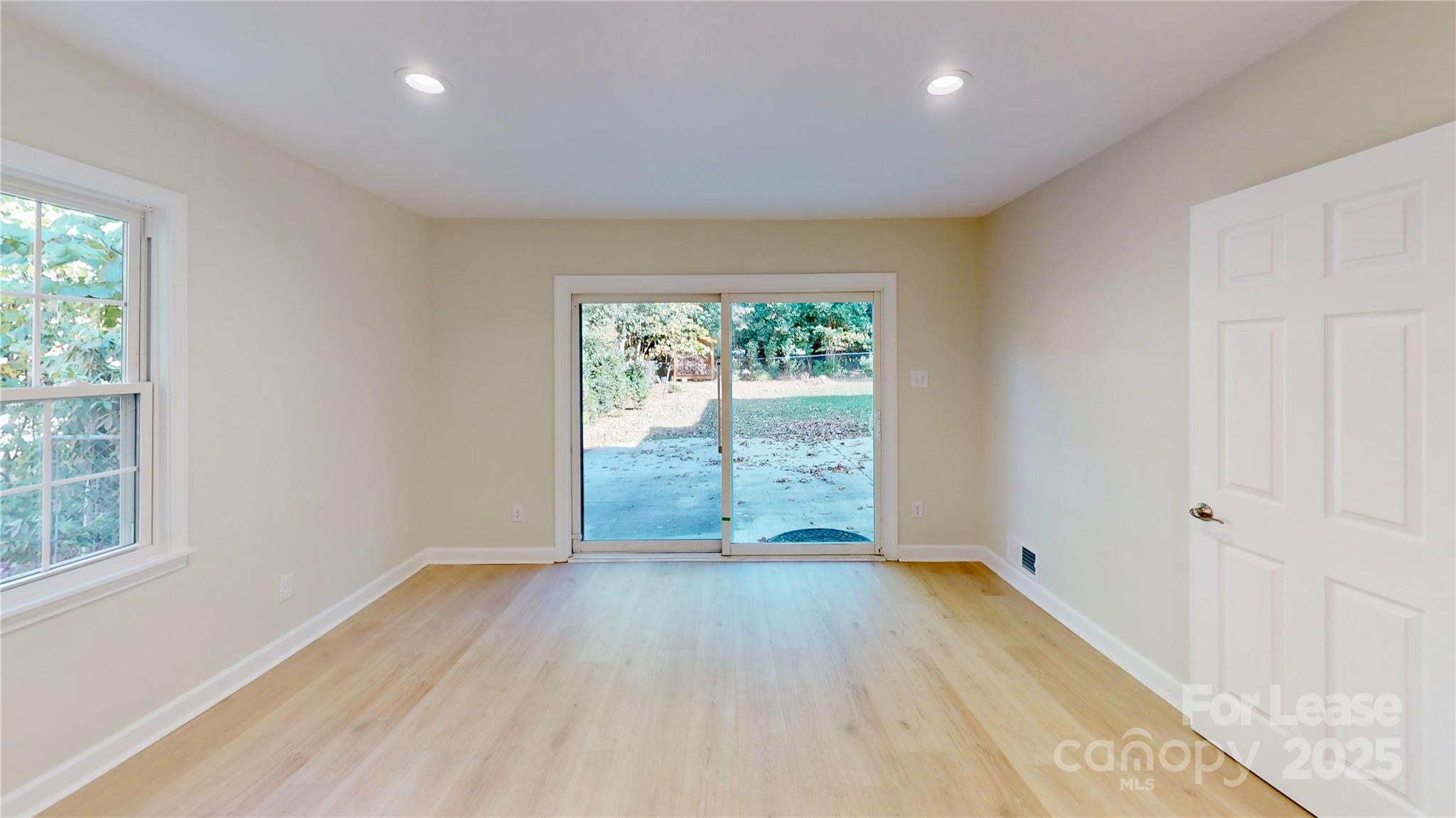 2844 Goneaway Road Charlotte, NC 28210 - Photo 39 of 41 an empty room with wooden floor and windows