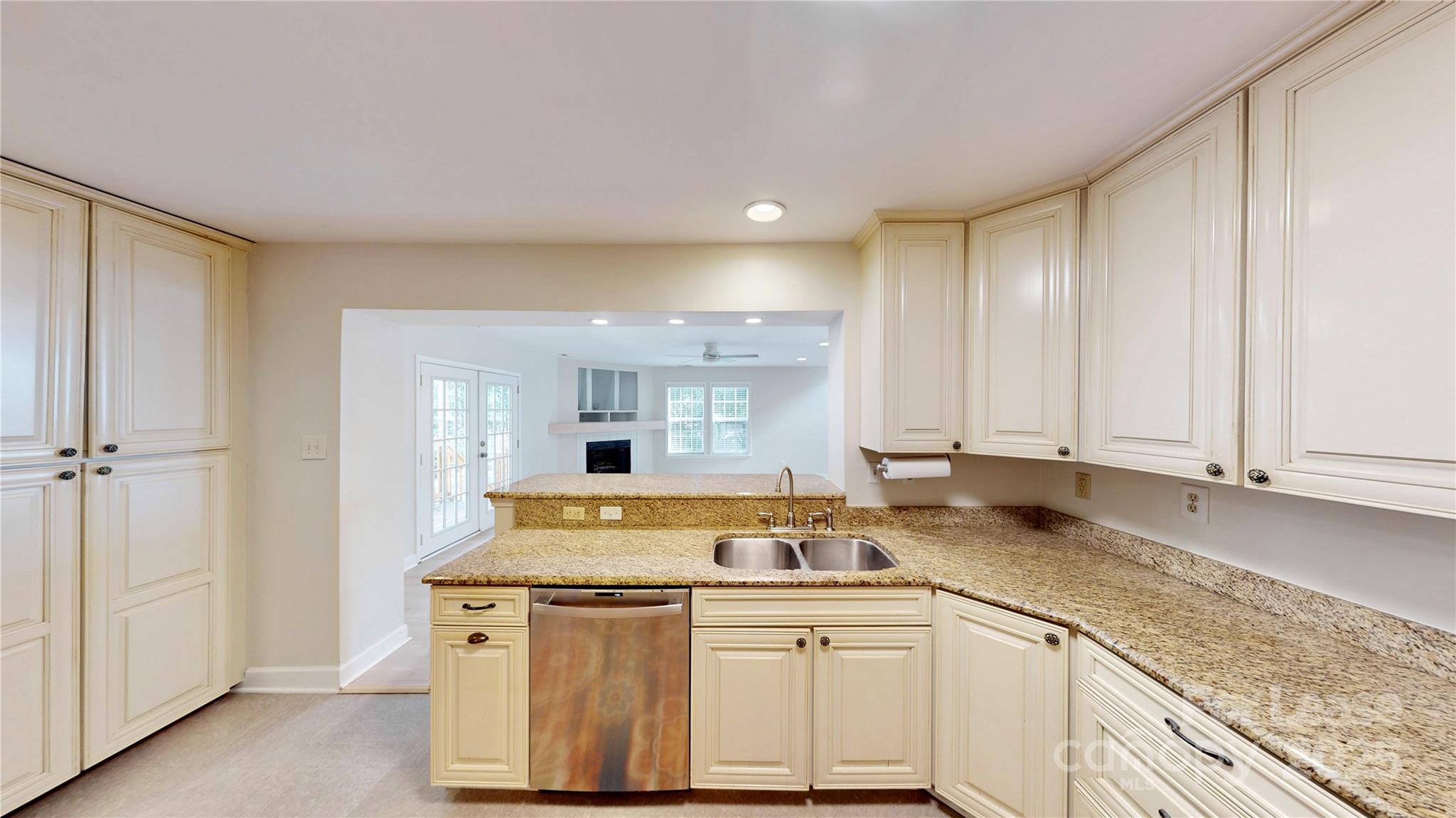 2844 Goneaway Road Charlotte, NC 28210 - Photo 8 of 41 a kitchen with stainless steel appliances granite countertop a sink a stove and white cabinets