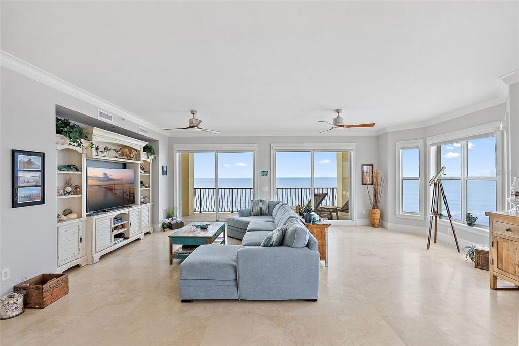 13630 Gulf Boulevard, Unit 700C Madeira Beach, FL 33708 - Photo 12 of 78 a living room with furniture and a flat screen tv