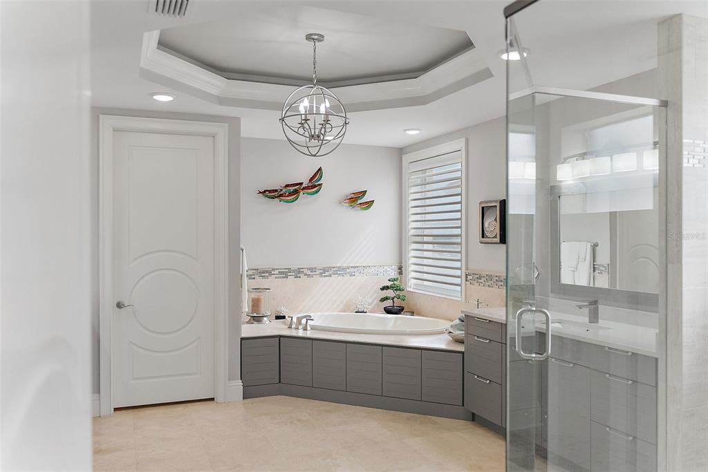 13630 Gulf Boulevard, Unit 700C Madeira Beach, FL 33708 - Photo 25 of 78 a bathroom with a tub sink and shower