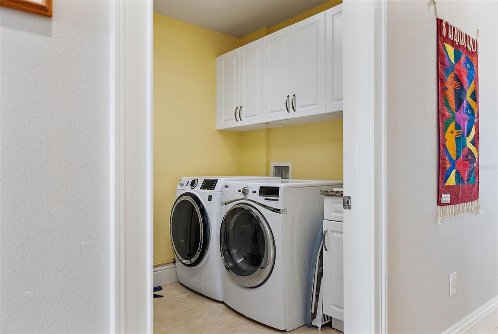 13630 Gulf Boulevard, Unit 700C Madeira Beach, FL 33708 - Photo 30 of 78 a utility room with dryer and washer