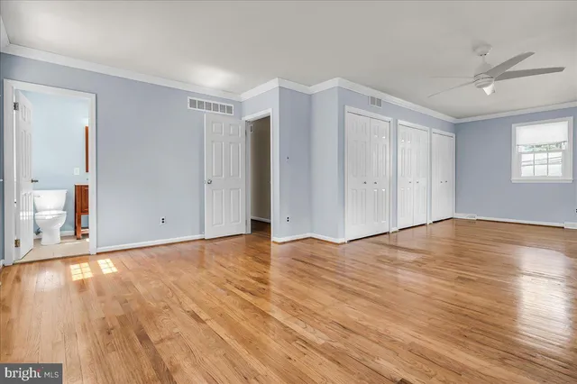 a view of empty room with wooden floor