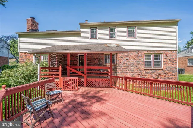 a view of a deck with wooden floor and floor to ceiling window