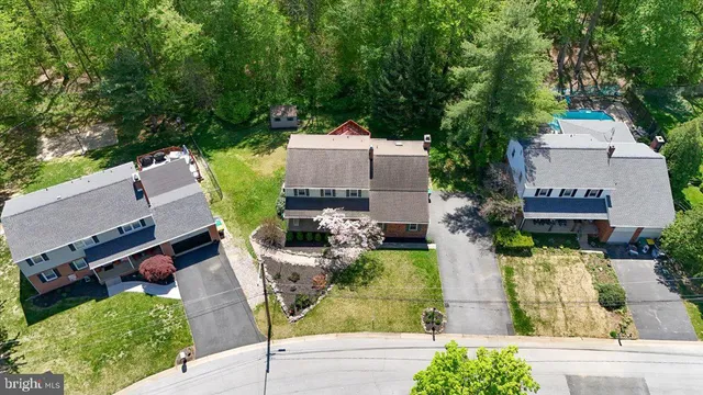 an aerial view of a house with garden space and street view