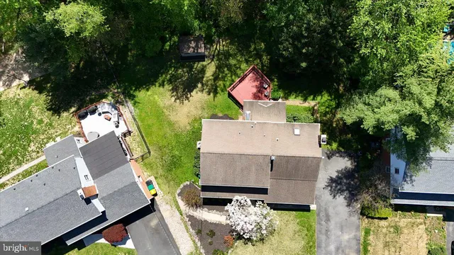 an aerial view of a house with a yard pool outdoor seating and yard