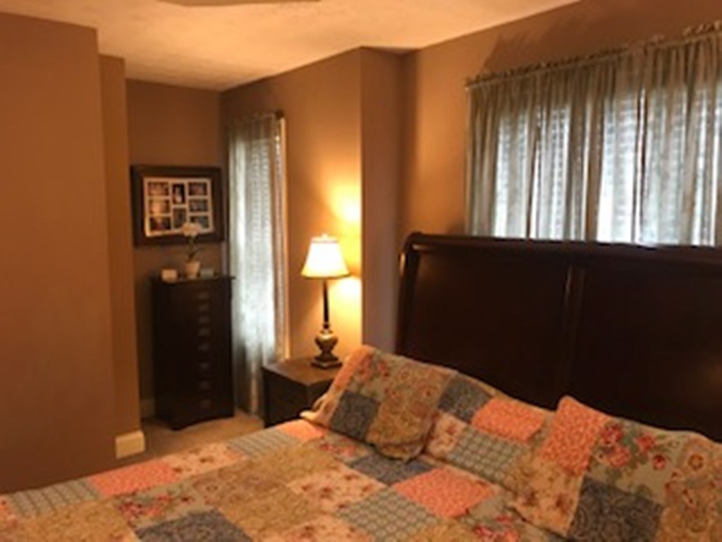2045 Zellner Road Forsyth, GA 31029 - Photo 14 of 33 a bedroom with a bed and wooden floor