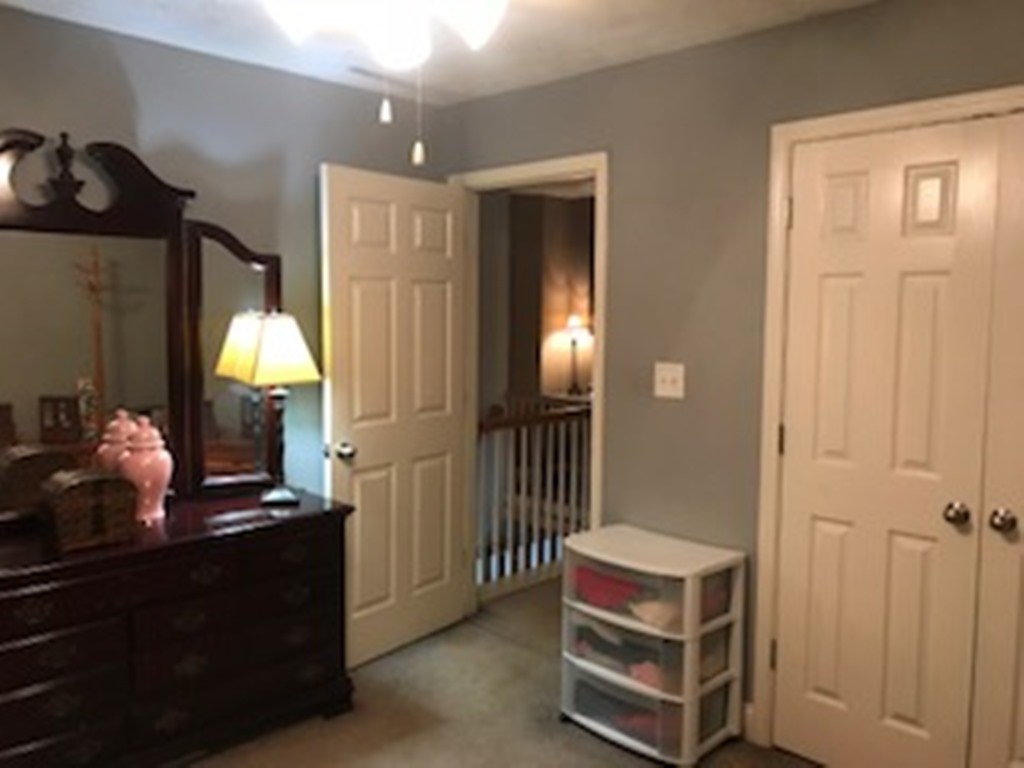 2045 Zellner Road Forsyth, GA 31029 - Photo 22 of 33 a room with a mirror and a lamp