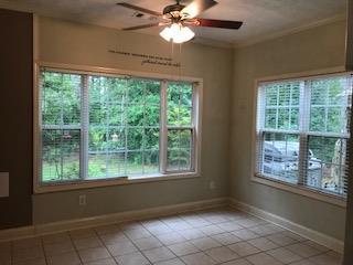 2045 Zellner Road Forsyth, GA 31029 - Photo 8 of 33 a view of an empty room with windows and chandelier fan