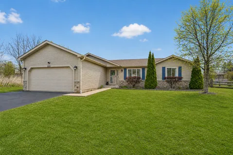 a front view of house with yard and green space