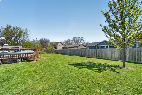 a view of a garden with wooden fence