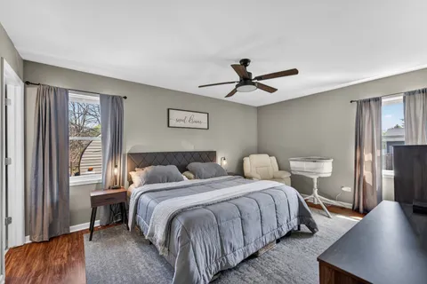 a bedroom with a bed and a large window