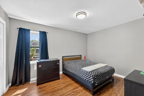 a bedroom with a bed and window