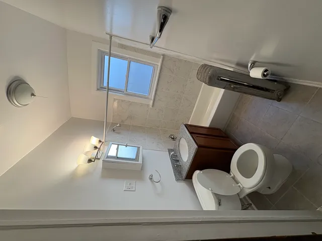 a bathroom with a toilet and a mirror