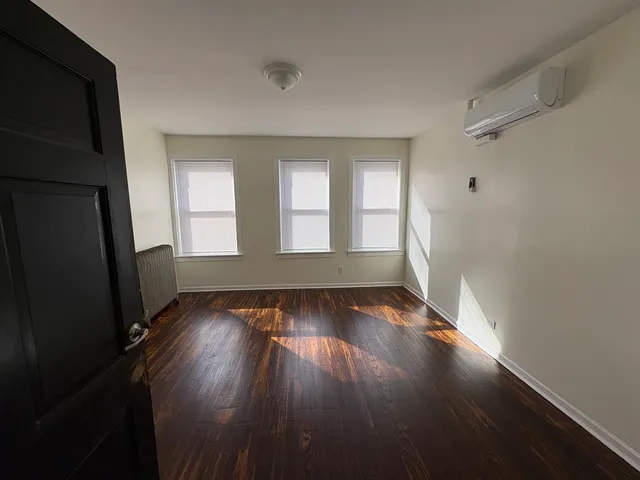 wooden floor in an empty room with a window