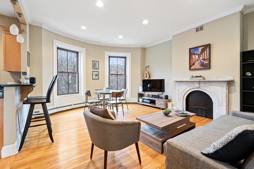 32 Union Park, Unit 2 Boston, MA 02118 - Photo 1 of 19 a living room with fireplace furniture and a flat screen tv